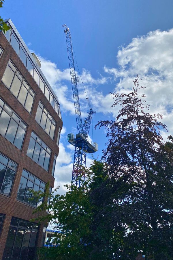 A crane sits in front of a building.