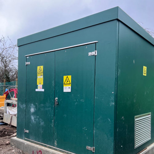An electrical substation installation with a sign on it.